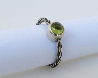 Braided sterling silver ring with natural peridot stone