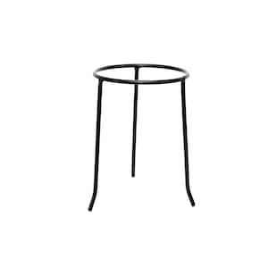 May include: A black metal stand featuring a circular top ring supported by three thin, slightly curved legs. The structure is constructed from slender, smooth metal rods, providing a stable base for elevated placement of various objects.