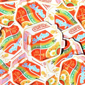 May include: A collection of colorful stickers featuring the Indomie Mi Goreng instant noodle brand. The stickers are designed with a rainbow gradient and feature the brand's logo and product name in a stylized font. The stickers are perfect for adding a touch of fun and personality to laptops, water bottles, or other surfaces.