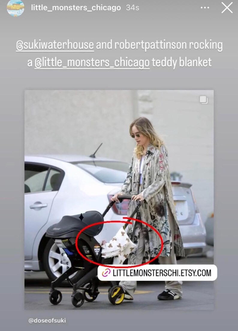 May include: A woman in a long, patterned coat pushes a stroller with a white and brown teddy bear blanket inside. The stroller has black wheels and a black canopy. The text "LITTLEMONSTERCHI.ETSY.COM" is visible in the bottom right corner of the image.