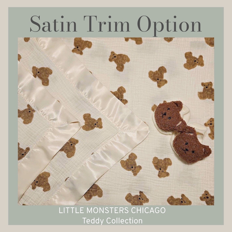May include: A white muslin baby blanket with a satin trim and a brown teddy bear print. The blanket is folded in half and has a pair of brown teddy bear booties on top. The text "LITTLE MONSTERS CHICAGO Teddy Collection" is printed on the bottom of the blanket.