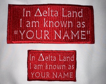 May include: Two red embroidered patches with white text. The top patch reads "In Delta Land I am known as "YOUR NAME"". The bottom patch reads "In Delta Land I am known as YOUR NAME".