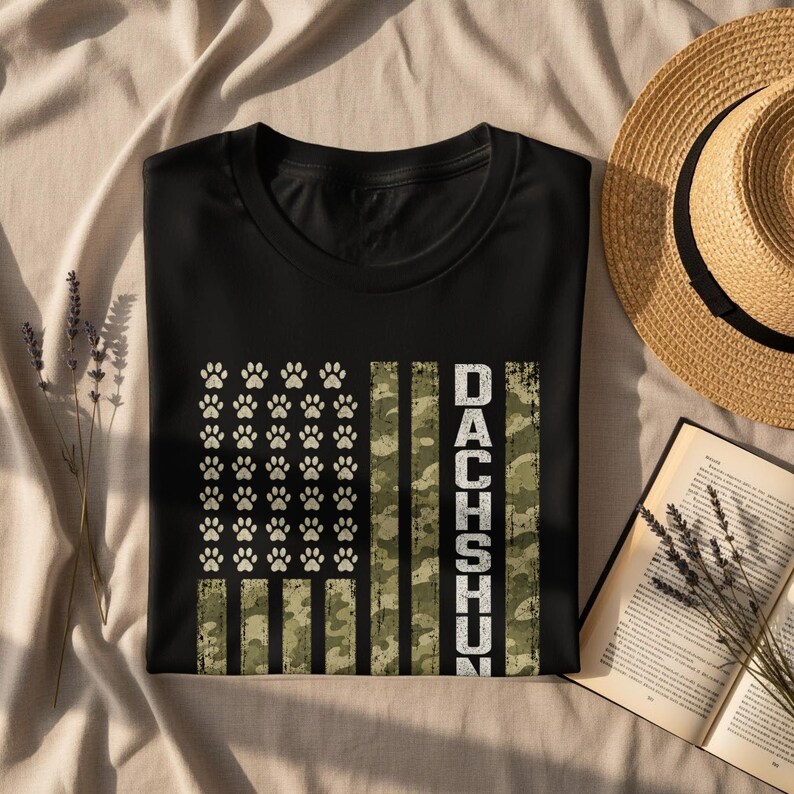Black t-shirt with distressed American flag design featuring paw prints and the word "DACHSHUND".
