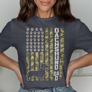 T-shirt with American flag design featuring paw prints and a dachshund silhouette.