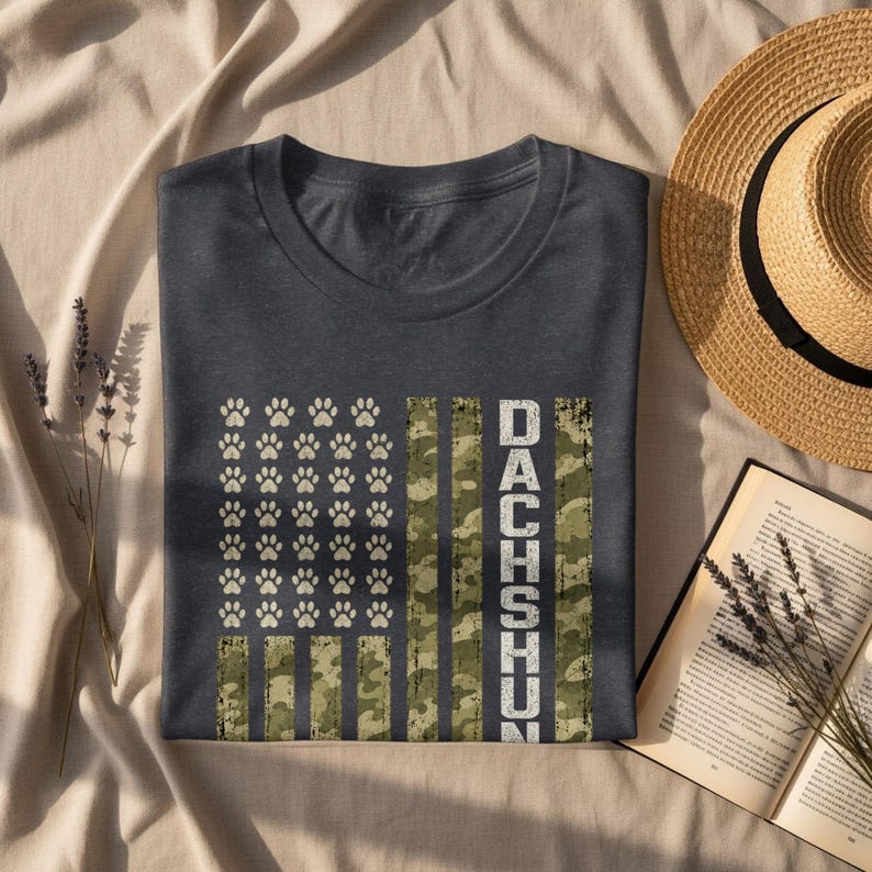 Dark t-shirt with paw print American flag design and the word Dachshund.