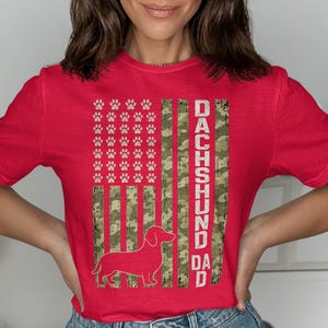 Red t-shirt with Dachshund silhouette, paw prints and "DACHSHUND DAD" text.