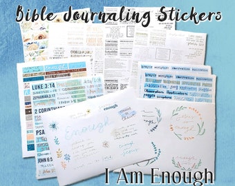 May include: A collection of Bible journaling stickers with various designs and phrases, including "Jesus is enough", "I am enough", and "Created in Christ". The stickers are on a white background with a blue and white floral pattern.