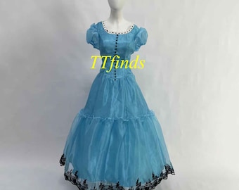 May include: A light blue dress with a black and white trim. The dress has a ruffled skirt and a fitted bodice. The dress is on a white mannequin.