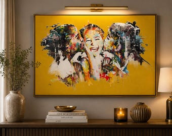 May include: A rectangular wall art piece featuring a vibrant yellow background with an abstract, expressive painting of three figures. The central figure is laughing while being kissed on both cheeks by the figures on the left and right sides.