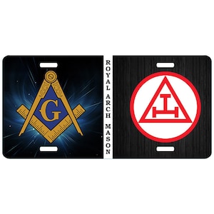 May include: A license plate featuring Masonic symbols. The left side displays a blue and gold square and compass with the letter "G" in the center against a blue and white background. The right side shows a red and white symbol within a red circle on a black wood grain background. The text "ROYAL ARCH MASON" is printed vertically.