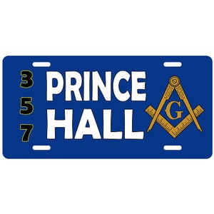 May include: Blue license plate with the words "PRINCE HALL" in white, and the numbers 3, 5, and 7 in black and yellow. A Masonic symbol is on the right side.