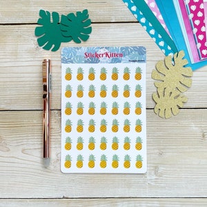 May include: A sheet of 49 pineapple stickers on a white background. The stickers are yellow with green tops and are arranged in a grid pattern. The sheet is labeled "StickerKitten Pineapple Stickers".