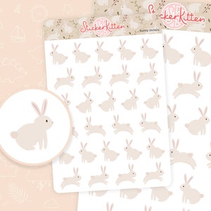 May include: A sheet of 36 bunny stickers. The stickers are white with pink accents and are arranged in a grid pattern. The stickers are ideal for adding a touch of whimsy to your planner, journal, or laptop.