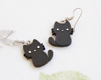 May include: A pair of black cat earrings with white eyes and a silver hook. The cat earrings are made of a lightweight material and are perfect for everyday wear.