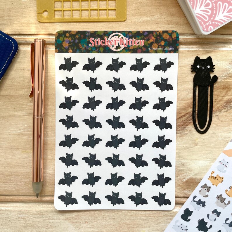 May include: A sheet of 49 black bat stickers with the text "Sticker Kitten Halloween Stickers" at the top.