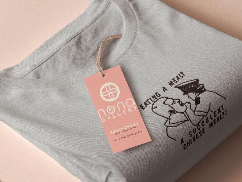 An embroidered light grey t-shirt design of the Australian Jack Karlson being arrested while he shouts Eating A Meal? A Succulent Chinese Meal?!