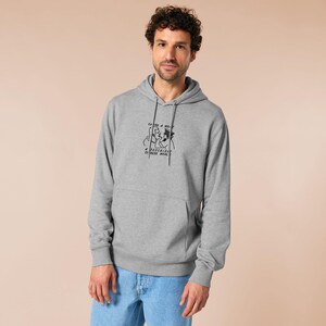 An embroidered light grey hoodie design of the Australian Jack Karlson being arrested while he shouts Eating A Meal? A Succulent Chinese Meal?!
