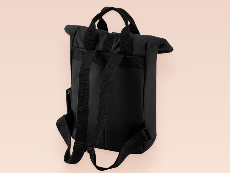 Black roll top backpack with a front pocket and an embroided mothman cryptid design with the lext live lamp lurk