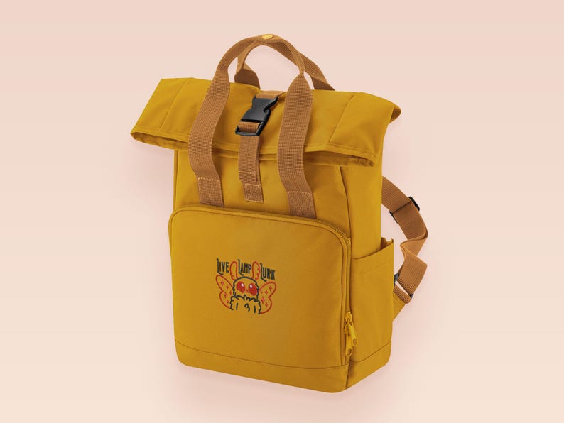Yellow roll top backpack with a front pocket and an embroided mothman cryptid design with the lext live lamp lurk