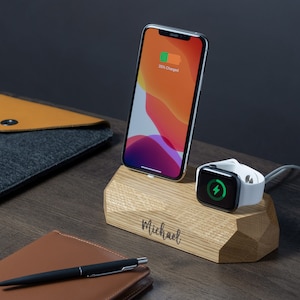 May include: A wooden charging station with a phone and a watch charging on it. The station is engraved with the name "Michael".