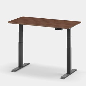 May include: A walnut brown standing desk with black adjustable legs and a control panel on the underside of the desktop.