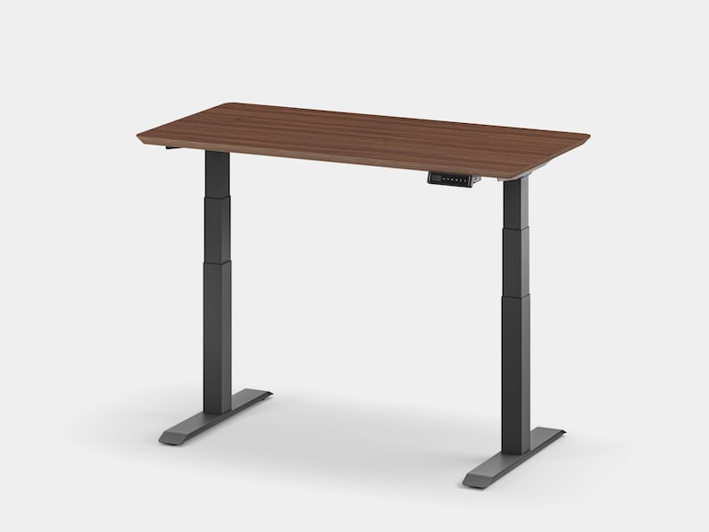 May include: A walnut brown standing desk with black adjustable legs and a control panel on the underside of the desktop.