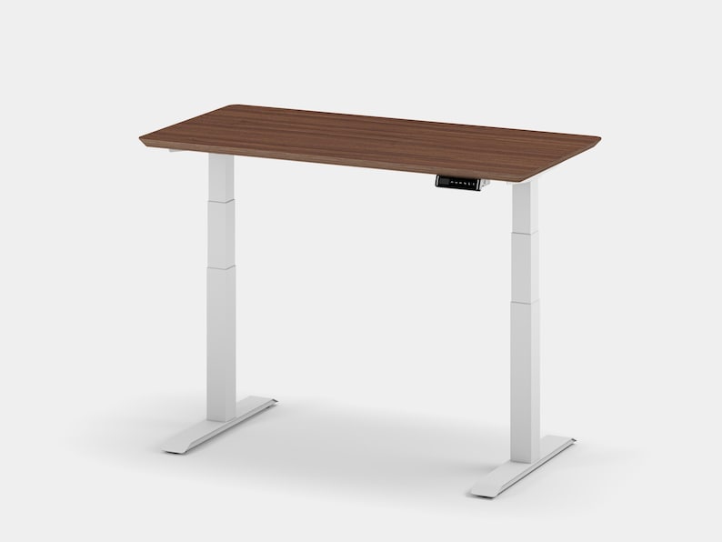 May include: White electric standing desk with a brown wood top. The desk has a control panel on the front of the top.