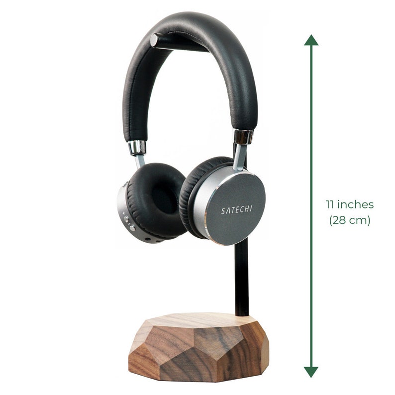 May include: A black and silver headphone stand with a wooden base. The stand is 11 inches (28 cm) tall and features the brand name "SATECHI".