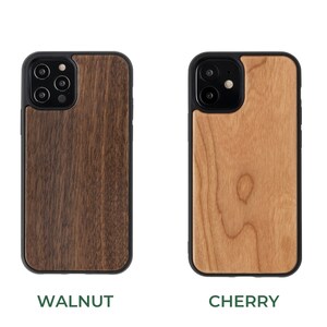 May include: Two phone cases made of wood. The case on the left is walnut wood and the case on the right is cherry wood.