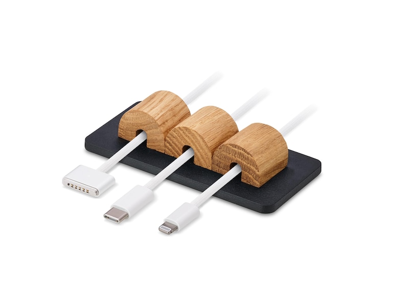 May include: Cable tidy featuring three wooden cable holders on a black base. White cables with various connectors are inserted through the wooden holders. The organiser is designed to manage and organise cables.