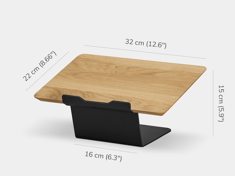 May include: A wooden laptop stand with a light brown wood grain surface and a black metal base. The stand measures 32 cm (12.6 inches) in width, 22 cm (8.66 inches) in depth, 15 cm (5.9 inches) in height, and has a 16 cm (6.3 inches) base width.