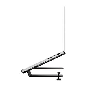 May include: A black laptop stand with a clamp, holding a silver laptop at an angle. The stand has a horizontal base and a platform to support the laptop. The laptop screen is open.