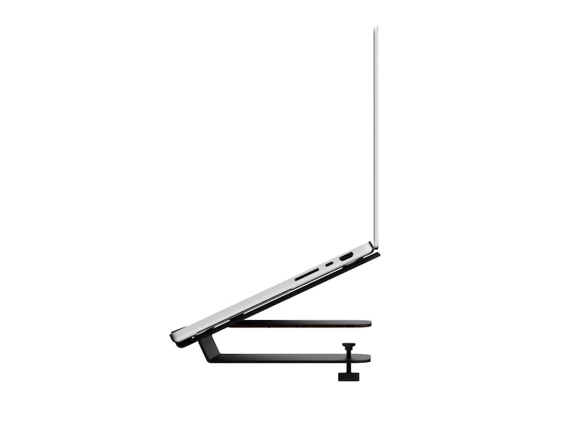 May include: A black laptop stand with a clamp, holding a silver laptop at an angle. The stand has a horizontal base and a platform to support the laptop. The laptop screen is open.