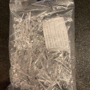 May include: A clear plastic bag filled with 200 clear crystal LED lights. The bag has a label that reads "ITEM NO: #210-871-08", "QTY: 200PCS", "COLOR: CRYSTAL", and "MADE IN CHINA".