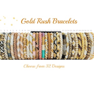 May include: A collection of 32 beaded bracelets in various colors and patterns, displayed on a black stand. The text "Gold Rush Bracelets" and "Choose from 32 Designs" are displayed in gold lettering.