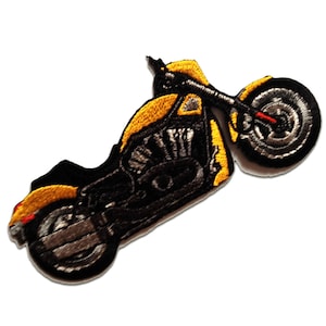 May include: Yellow and black embroidered motorcycle patch. The motorcycle is a cruiser style with a large front wheel.