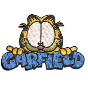 May include: Embroidered patch of Garfield the cat. The patch depicts Garfield's face in yellow and black, with the name "GARFIELD" in blue block letters beneath. The patch is set against a white backdrop.