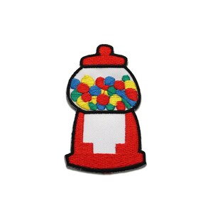 May include: Embroidered patch depicting a gumball machine. The patch is red with a white section and a clear globe filled with colourful gumballs. The top is red, and the design is outlined in black. A fun, nostalgic design.