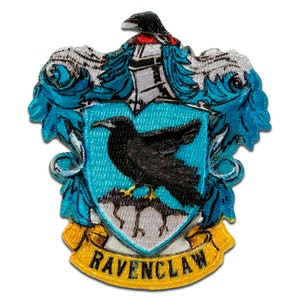 May include: Embroidered Ravenclaw house crest patch with a blue and silver shield, a black raven, and a yellow banner with the text "Ravenclaw".