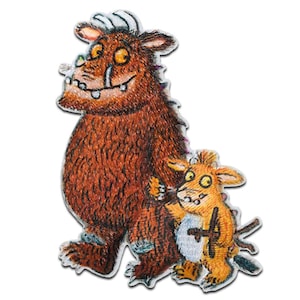 May include: An embroidered patch featuring a large, furry, brown monster with a toothy grin and a smaller, orange monster with a surprised expression. The larger monster is holding the smaller monster in its arms.