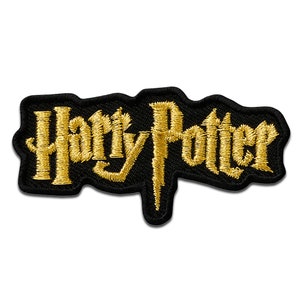 May include: A black and gold embroidered patch with the words "Harry Potter" in a stylized font.