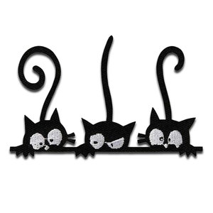 May include: Three black cats with white eyes peeking over a ledge. The cats have curled tails and are facing forward.