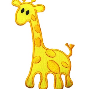 Può includere: Un toppa ricamata gialla di una giraffa dei cartoni animati con occhi neri. La girafa ha un collo lungo e macchie.