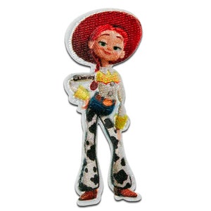 May include: An embroidered iron-on patch featuring a cartoon image of Jessie from Toy Story. She is wearing a red cowboy hat, a yellow shirt with a sheriff's star, blue jeans, and cow print trousers. The patch is white with a white border.