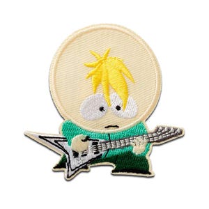 Pode incluir: Patch bordado com um personagem de desenho animado com cabelo loiro, vestindo uma camisa verde e tocando uma guitarra elétrica prateada. O personagem está em um fundo circular bege. O patch é projetado para aplicação em roupas ou acessórios.