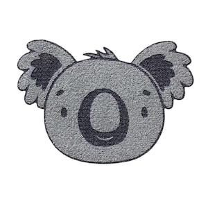 Pode incluir: Um tapete cinza com a cara de um coala com olhos pretos e nariz preto. O tapete tem uma textura felpuda.