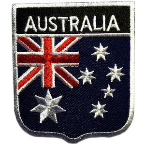 May include: A blue and white embroidered patch with the word "AUSTRALIA" in white letters on a black background. The patch features the Australian flag with the Union Jack in the top left corner and a constellation of seven white stars on a blue background.