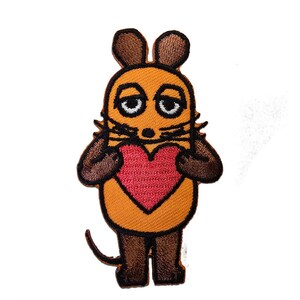 May include: Embroidered patch of a cartoon mouse holding a red heart. The mouse has an orange body, brown ears, arms, and legs, and black nose and whiskers. The patch is designed for application on clothing or accessories.