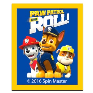 May include: A rectangular image with a yellow border features the text "PAW PATROL IS ON A ROLL!" above three cartoon dogs. The dogs are wearing uniforms and hats. The copyright notice "© 2016 Spin Master" is at the bottom.