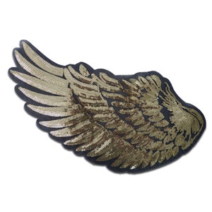 Peut inclure: Patch d'ailes d'ange en sequins dorés sur un support en tissu noir.